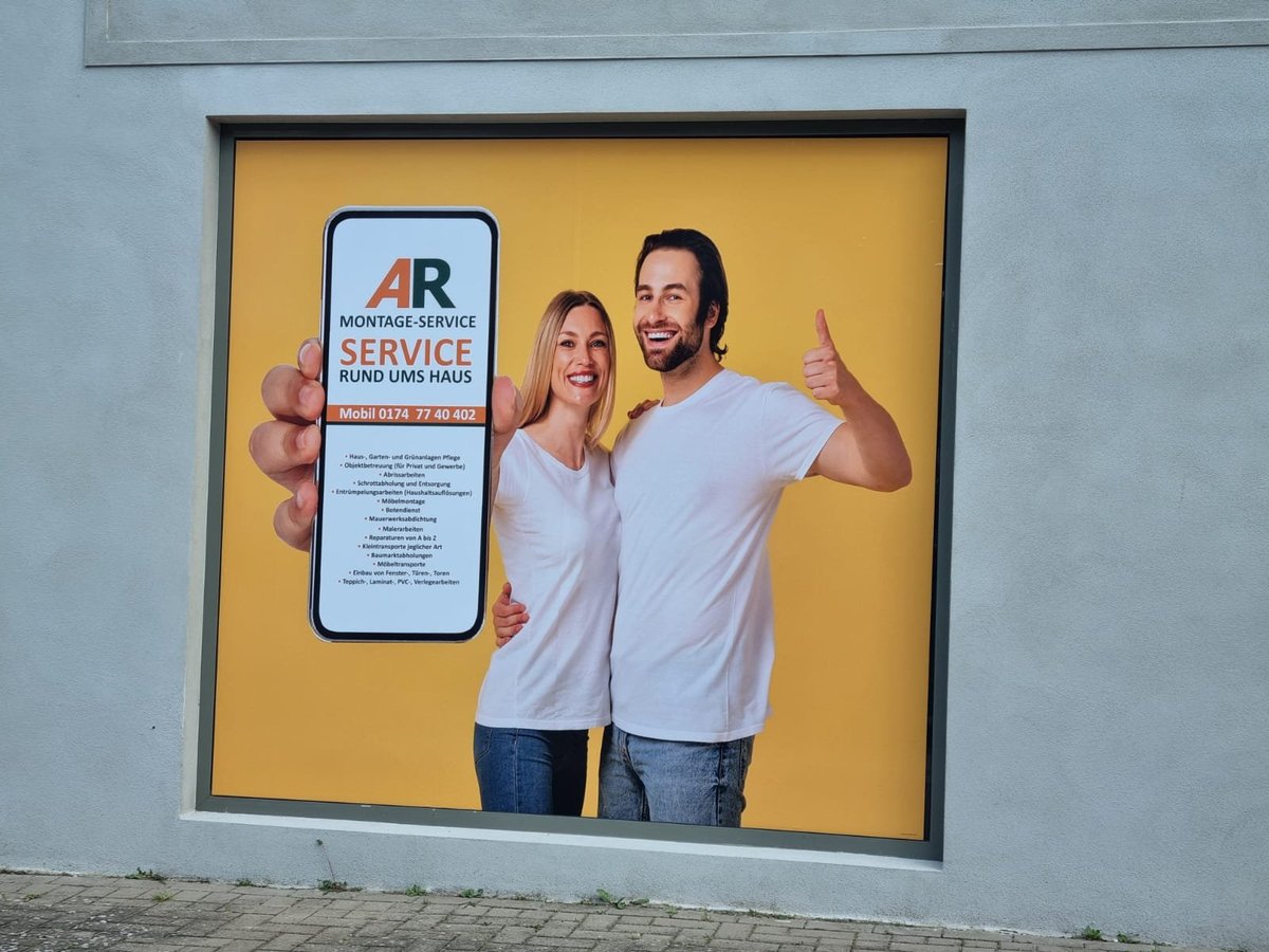Two people in light blue shirts giving thumbs up while holding a smartphone displaying an app service logo on yellow background